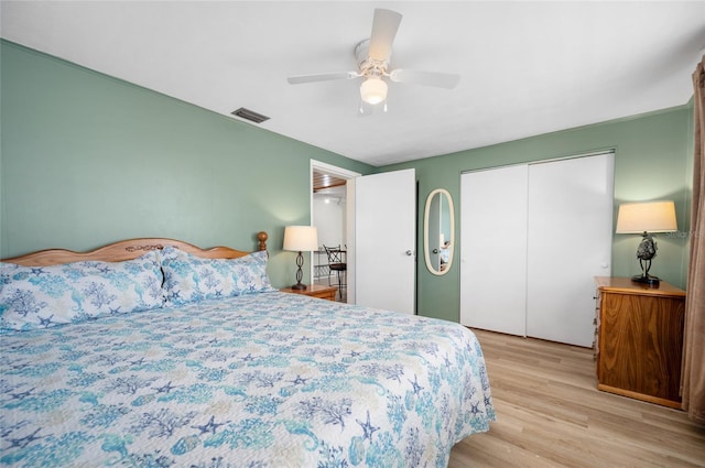 bedroom with ceiling fan, light hardwood / wood-style floors, and a closet