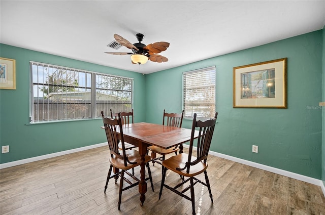 dining space featuring ceiling fan and light wood-type flooring