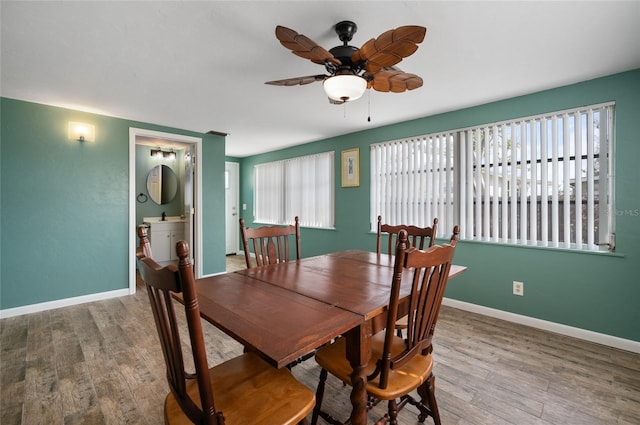 dining area featuring wood-type flooring and ceiling fan