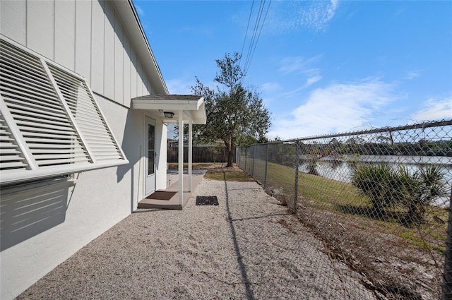 view of yard with a water view and a patio area