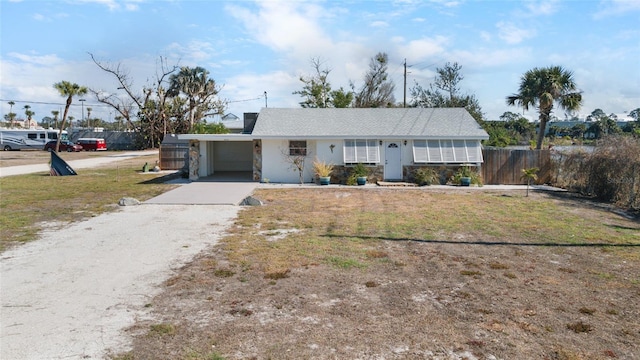 single story home featuring a garage and a front lawn