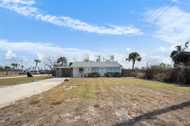 single story home featuring a carport