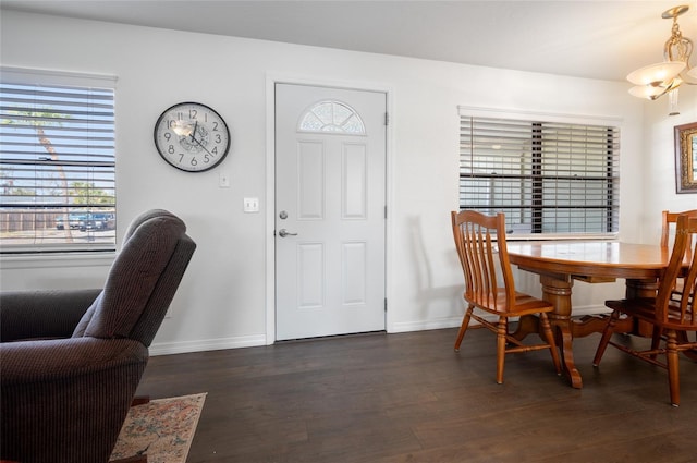 dining room with an inviting chandelier and dark hardwood / wood-style floors