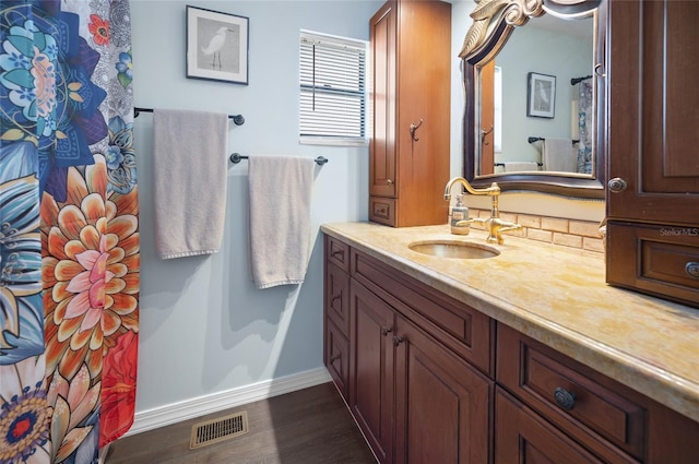 bathroom featuring hardwood / wood-style flooring and vanity