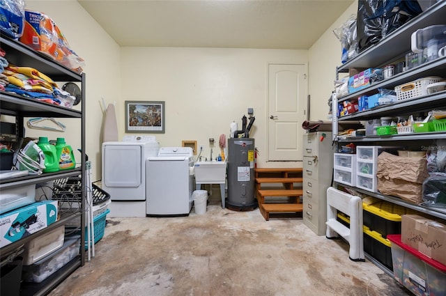 interior space with separate washer and dryer, electric water heater, and sink