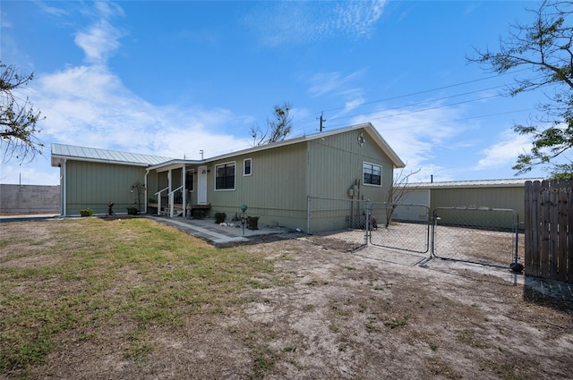 rear view of property with a lawn