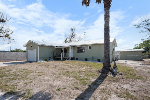 manufactured / mobile home with a garage and a front yard