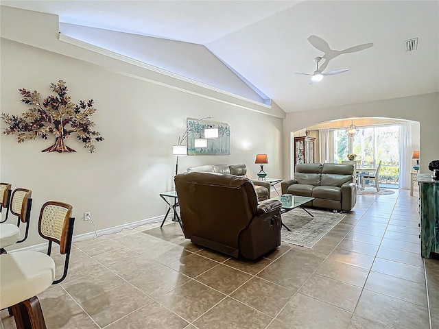 tiled living room featuring lofted ceiling and ceiling fan