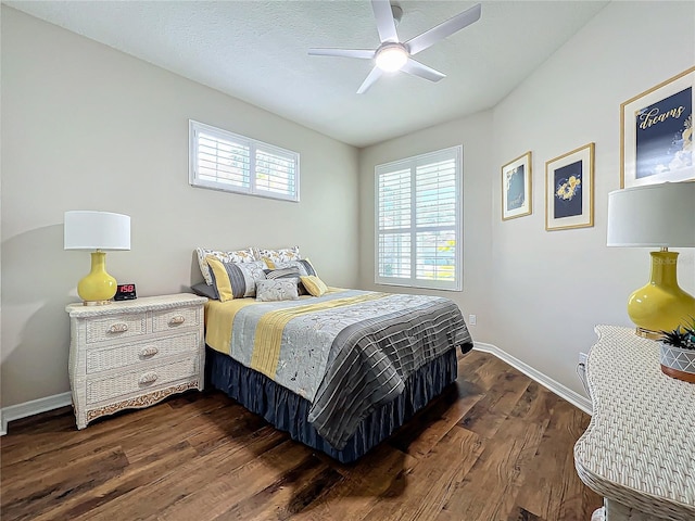 bedroom with a textured ceiling, dark hardwood / wood-style floors, and ceiling fan