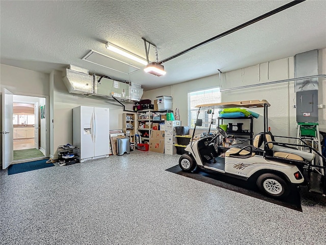 garage featuring a garage door opener, white refrigerator with ice dispenser, and electric panel