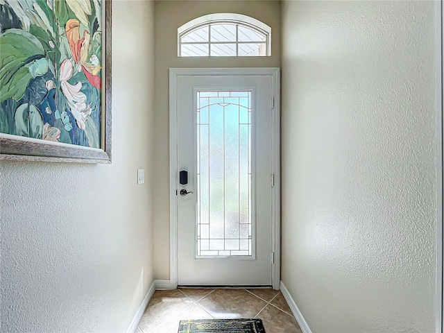 doorway to outside with light tile patterned floors and plenty of natural light