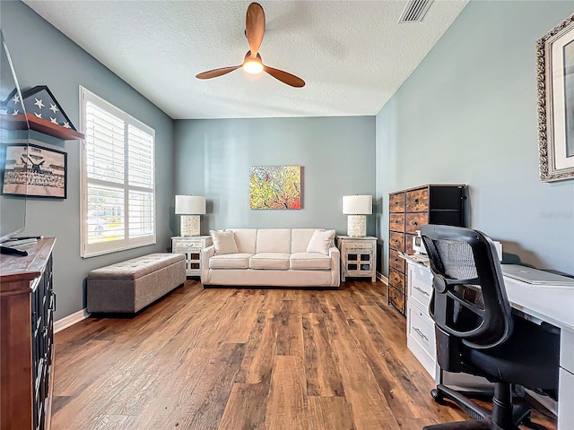 home office featuring hardwood / wood-style floors, a textured ceiling, and ceiling fan