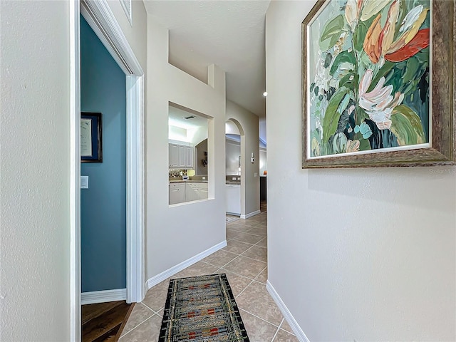 hallway with light tile patterned floors