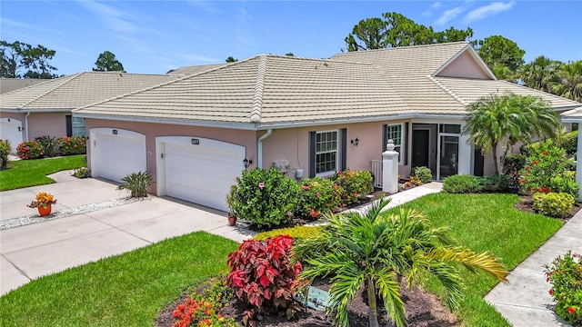 1577 Monarch Dr Unit 1577, Venice, FL 34293 - single story home with a tile roof, concrete driveway, stucco siding, a garage, and a front yard