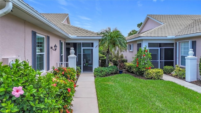 1577 Monarch Dr Unit 1577, Venice, FL 34293 - doorway to property featuring stucco siding and a lawn