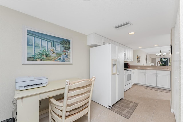 kitchen featuring sink, a chandelier, pendant lighting, white appliances, and white cabinets