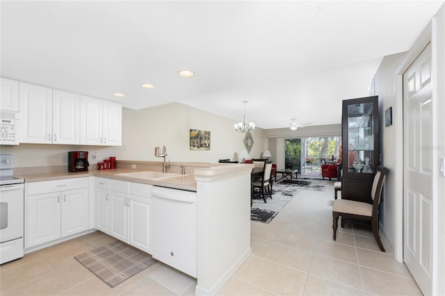 kitchen featuring white cabinetry, sink, white appliances, and kitchen peninsula