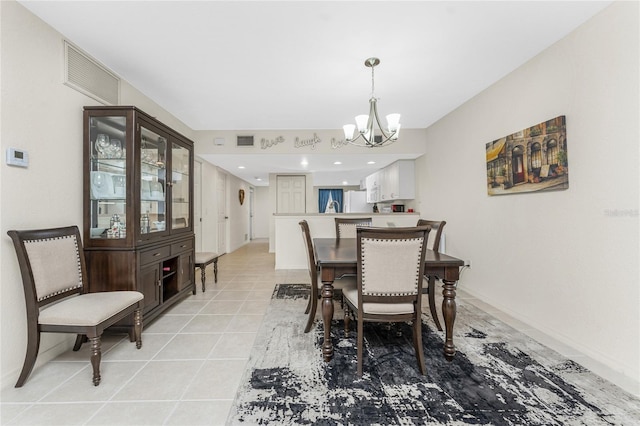 dining space featuring light tile patterned floors and an inviting chandelier