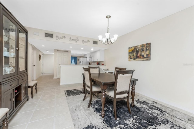 tiled dining room featuring a notable chandelier