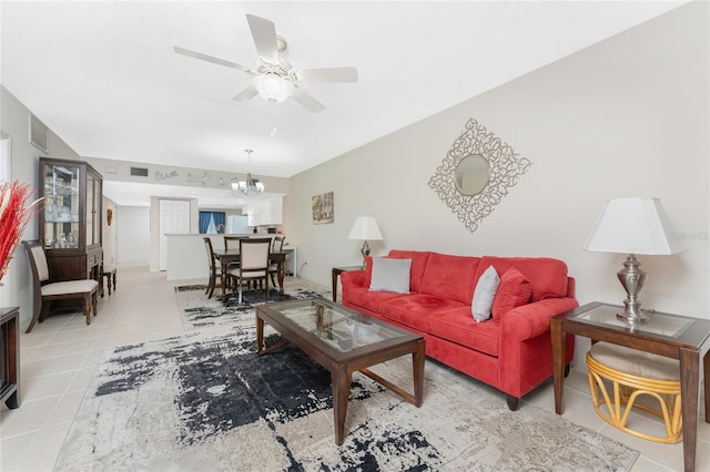 living room featuring light tile patterned floors and ceiling fan with notable chandelier