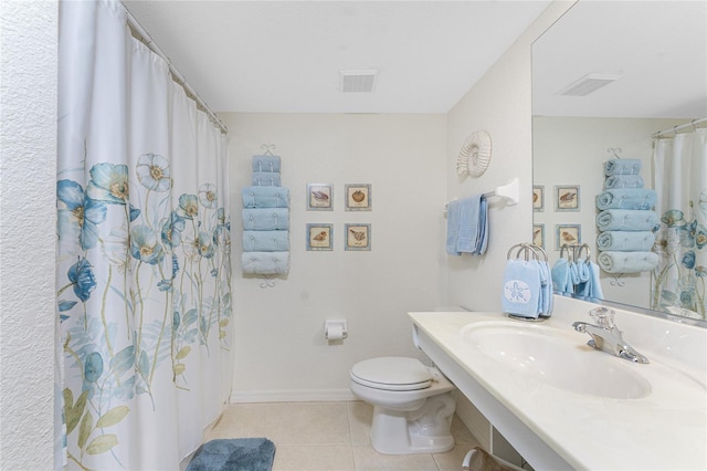 bathroom with tile patterned flooring, sink, and toilet