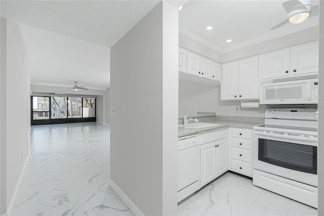 kitchen with crown molding, white appliances, sink, and white cabinets