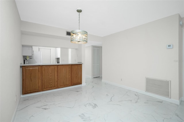 kitchen featuring decorative light fixtures and white refrigerator