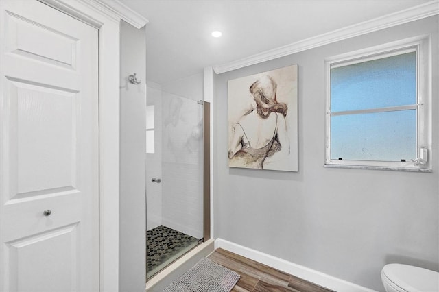 bathroom featuring walk in shower, wood-type flooring, crown molding, and toilet