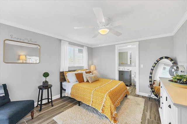 bedroom with ornamental molding, hardwood / wood-style floors, ceiling fan, and ensuite bath