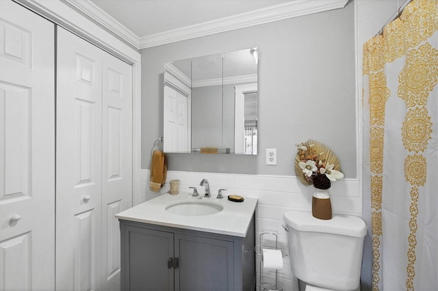 bathroom with crown molding, vanity, and toilet