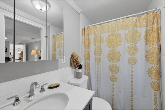 bathroom with crown molding, vanity, and toilet