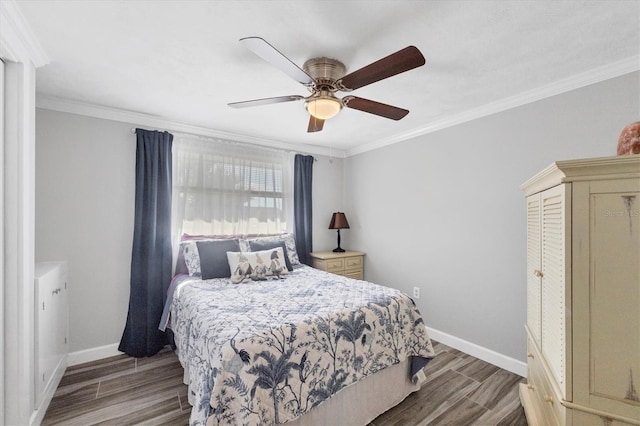 bedroom featuring hardwood / wood-style floors, ornamental molding, and ceiling fan