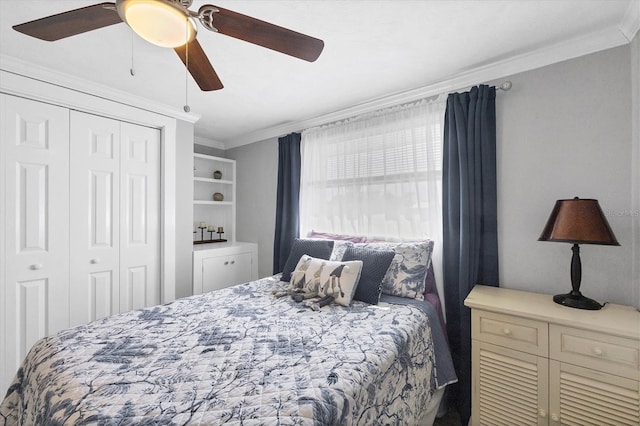 bedroom featuring ornamental molding, ceiling fan, and a closet