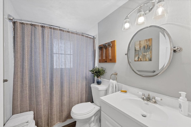 bathroom featuring a shower with curtain, vanity, and toilet