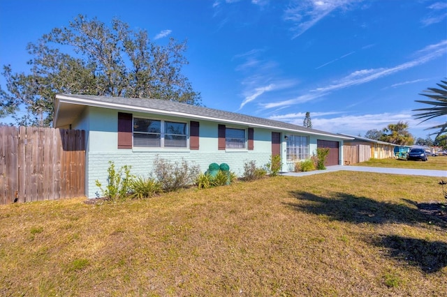 ranch-style house with a garage and a front yard