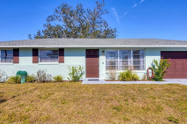 ranch-style house with a garage and a front yard