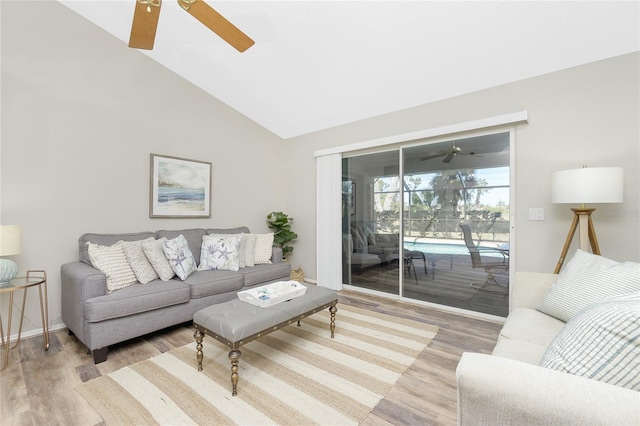 living room featuring ceiling fan, lofted ceiling, and hardwood / wood-style floors