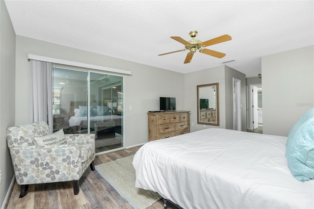 bedroom with hardwood / wood-style flooring, ceiling fan, access to exterior, and a textured ceiling