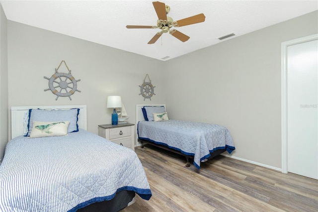 bedroom with ceiling fan and light wood-type flooring