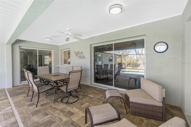 view of patio / terrace with ceiling fan and glass enclosure