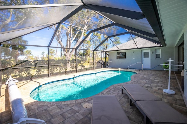 view of pool with a patio and glass enclosure