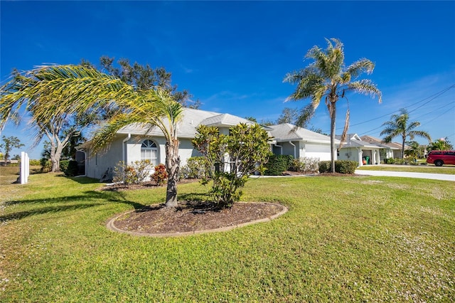 view of front of house with a garage and a front lawn