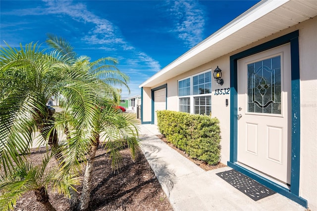 doorway to property with stucco siding