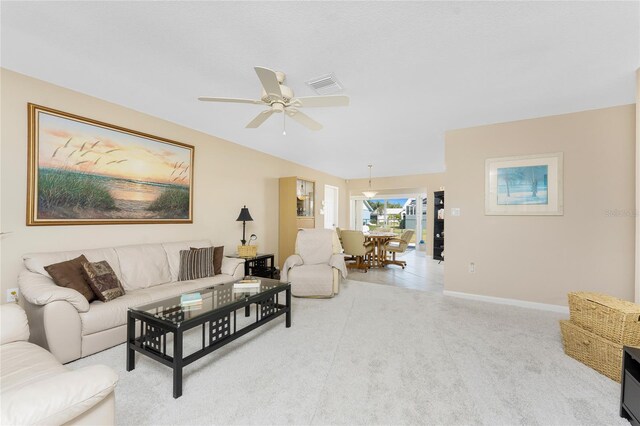 living room with light carpet, ceiling fan, visible vents, and baseboards