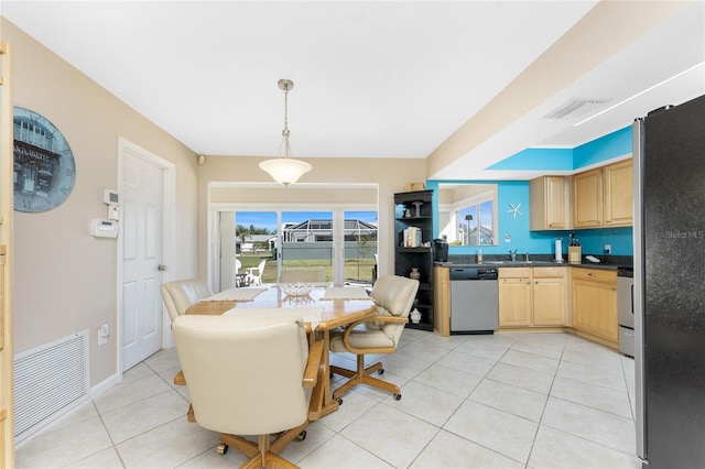 dining space with light tile patterned floors, visible vents, and baseboards