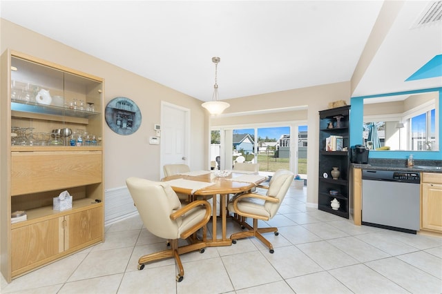 dining area featuring light tile patterned floors and visible vents