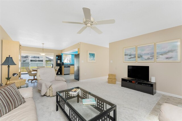 living area with ceiling fan and baseboards