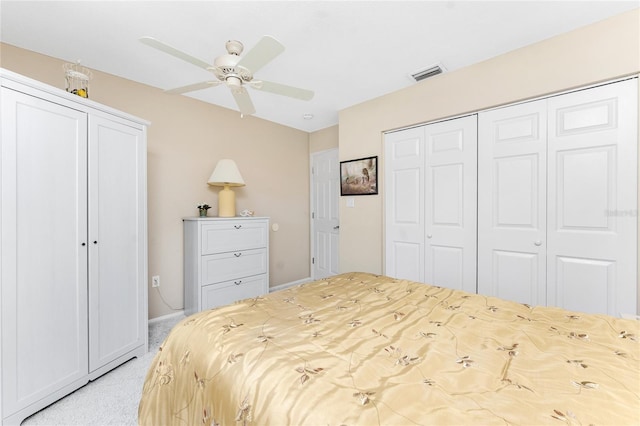 bedroom with light colored carpet, a closet, visible vents, and ceiling fan