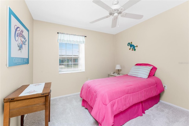 bedroom with light carpet, baseboards, and a ceiling fan