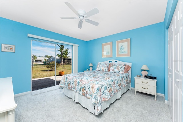 bedroom featuring light carpet, access to outside, baseboards, and a closet